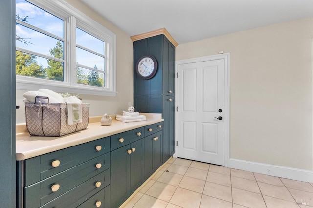 bathroom with baseboards and tile patterned flooring