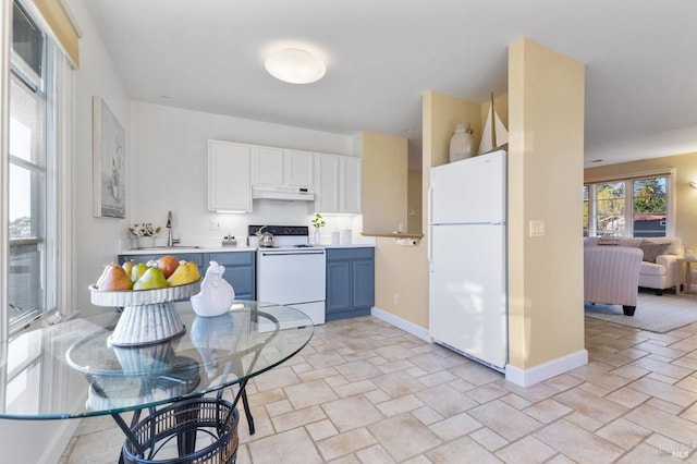 kitchen featuring light countertops, white appliances, baseboards, under cabinet range hood, and blue cabinets