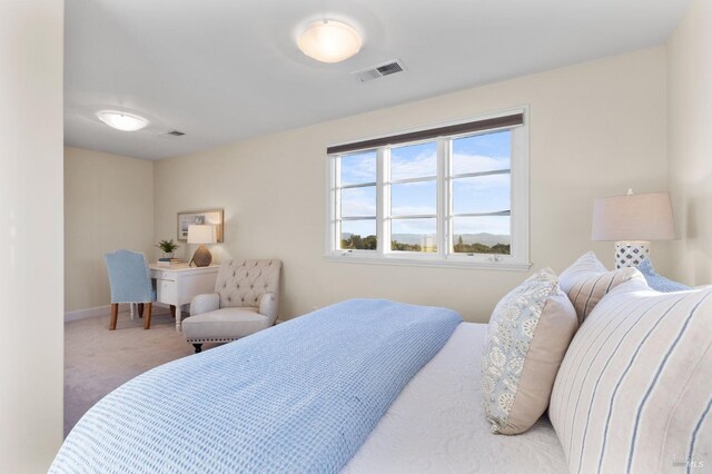 carpeted bedroom featuring baseboards and visible vents