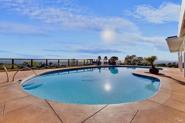 view of swimming pool with a patio and a fenced in pool