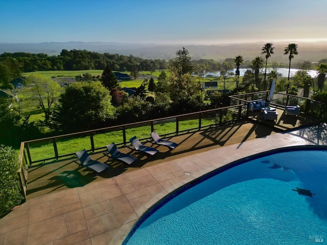 outdoor pool with a wooden deck