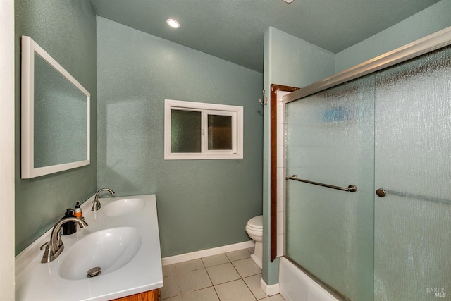 full bathroom with tile patterned flooring, a sink, toilet, and baseboards