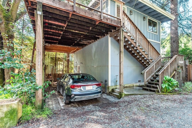 view of car parking featuring an attached carport and stairs