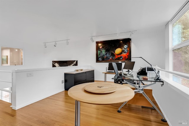 office featuring track lighting, baseboards, and wood finished floors