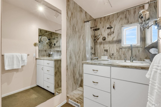 full bath with a shower with curtain, visible vents, baseboards, track lighting, and vanity