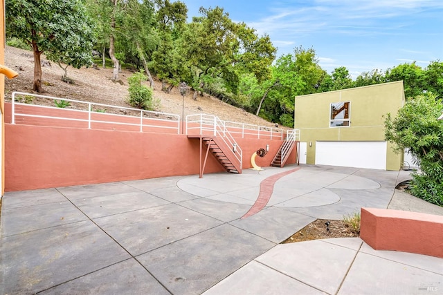 view of patio / terrace with stairs and a tennis court