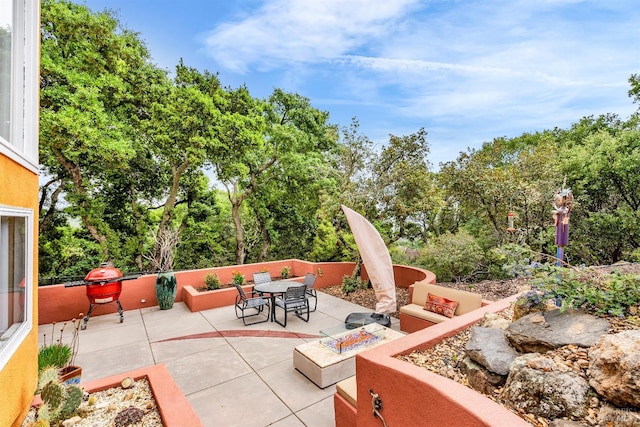 view of patio / terrace with a fire pit and outdoor dining space