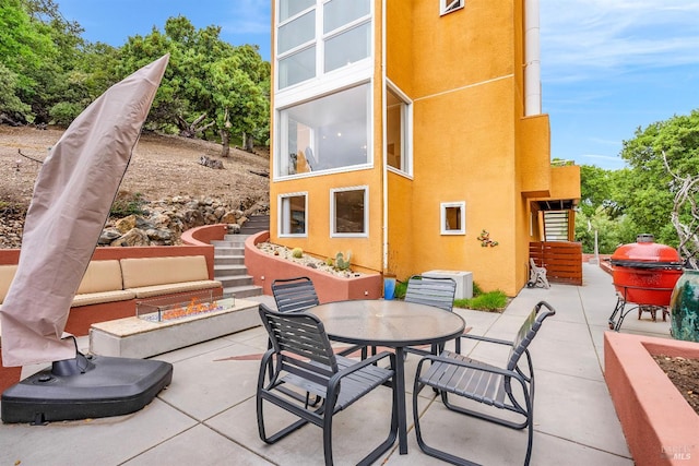 view of patio featuring outdoor dining space and stairway