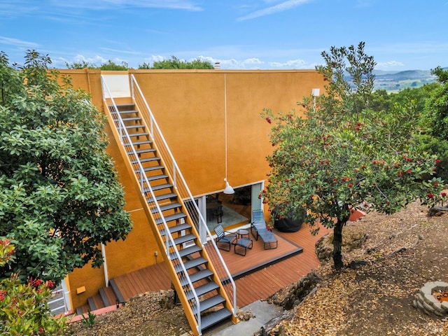 details featuring stairs and stucco siding