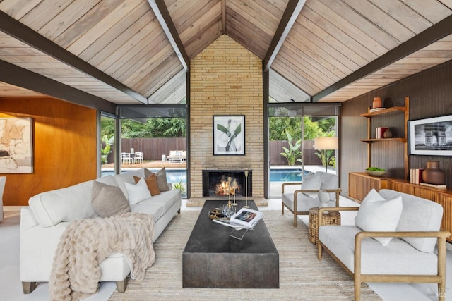 living room featuring a brick fireplace, plenty of natural light, wooden walls, and expansive windows