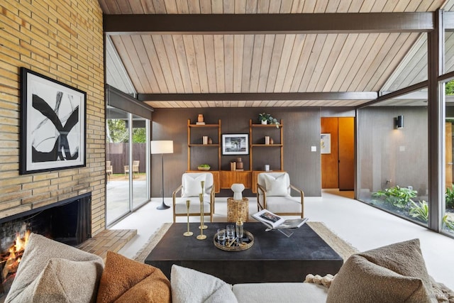 living room featuring lofted ceiling with beams, carpet flooring, and a brick fireplace