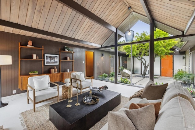 living room featuring concrete floors, lofted ceiling with beams, and wood walls
