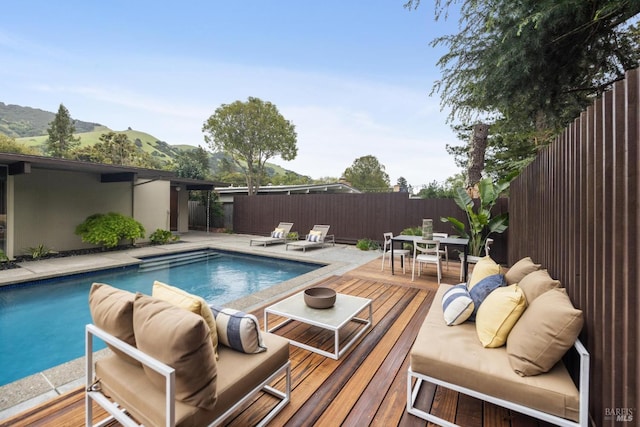 view of pool with a fenced backyard, an outdoor living space, outdoor dining area, and a fenced in pool