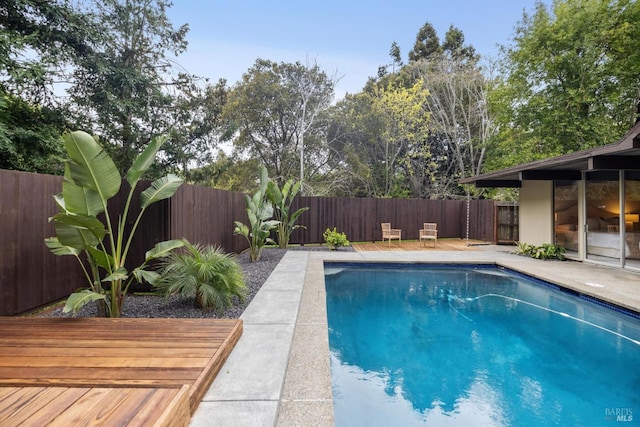 view of swimming pool featuring a fenced backyard and a fenced in pool