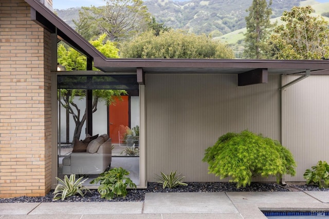 exterior space with brick siding and a mountain view