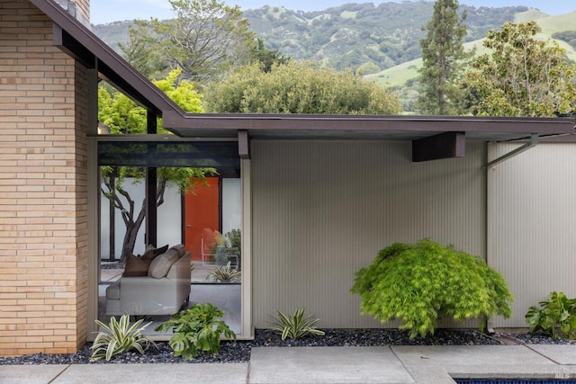 exterior space with brick siding and a mountain view
