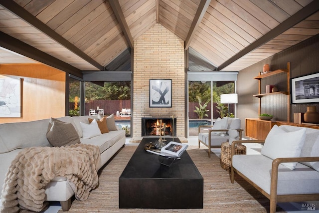 living room with wooden ceiling, a brick fireplace, lofted ceiling with beams, and a wealth of natural light
