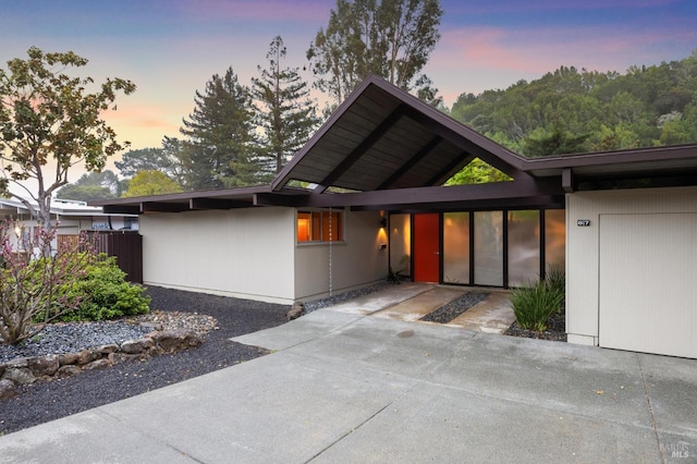 view of front of house featuring a patio area and fence