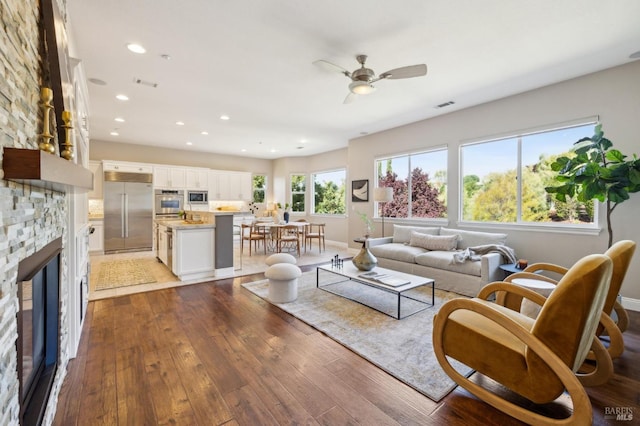 5232 Sunridge Dr, Fairfield, CA 94534 - living area featuring a ceiling fan, a stone fireplace, recessed lighting, visible vents, and hardwood / wood-style flooring