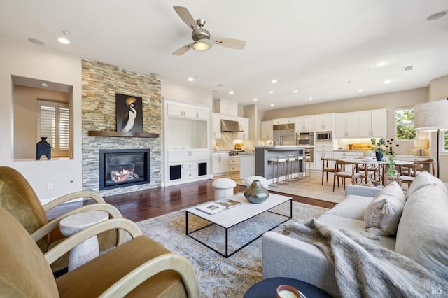 5232 Sunridge Dr, Fairfield, CA 94534 - living area with light wood-type flooring, a stone fireplace, recessed lighting, visible vents, and ceiling fan