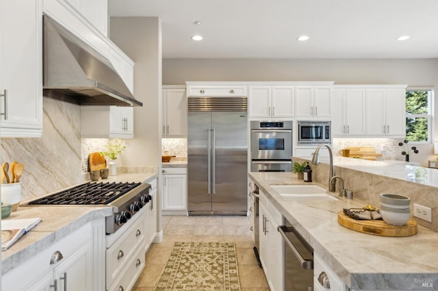 5232 Sunridge Dr, Fairfield, CA 94534 - kitchen with under cabinet range hood, built in appliances, a sink, and backsplash