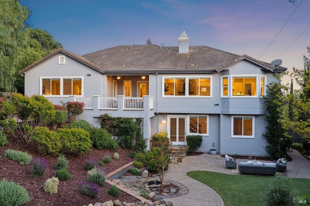 5232 Sunridge Dr, Fairfield, CA 94534 - rear view of house featuring outdoor lounge area, a chimney, a patio area, and stucco siding