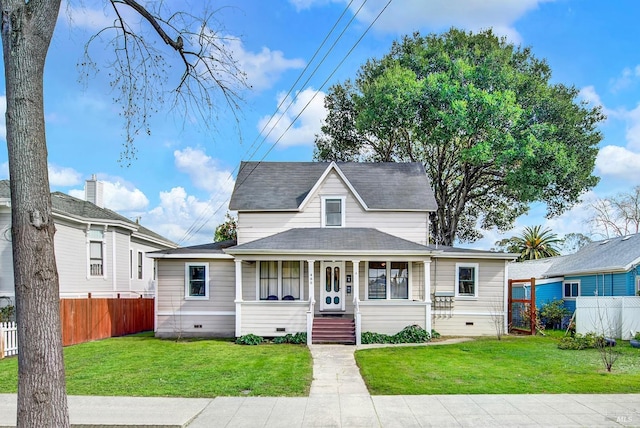 view of front of house featuring a front yard, a porch, crawl space, and fence