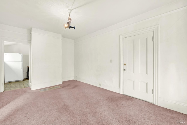 empty room featuring light colored carpet