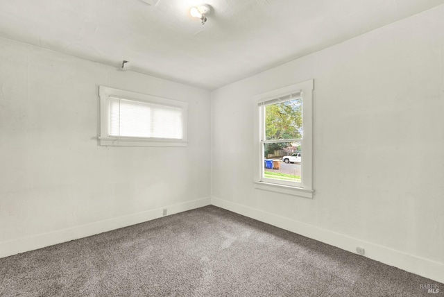 carpeted spare room with baseboards