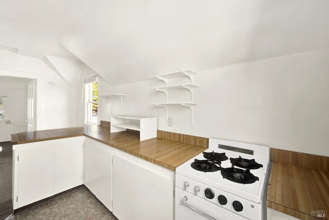 kitchen featuring a peninsula, lofted ceiling, white cabinetry, gas range gas stove, and open shelves