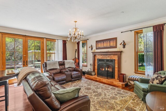 11900 Hwy 116, Guerneville, CA 95446 - living area featuring an inviting chandelier, crown molding, wood finished floors, a fireplace, and french doors