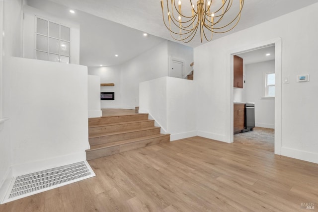 stairs featuring wood finished floors, recessed lighting, baseboards, and visible vents