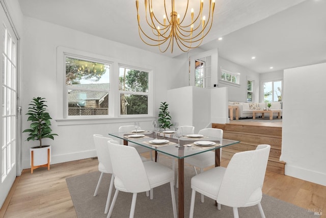 dining area featuring a healthy amount of sunlight, light wood finished floors, and recessed lighting