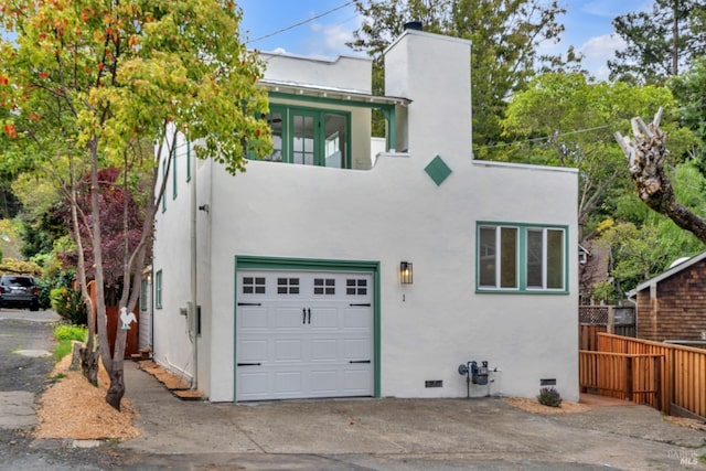 view of front of house featuring fence, crawl space, stucco siding, and a garage