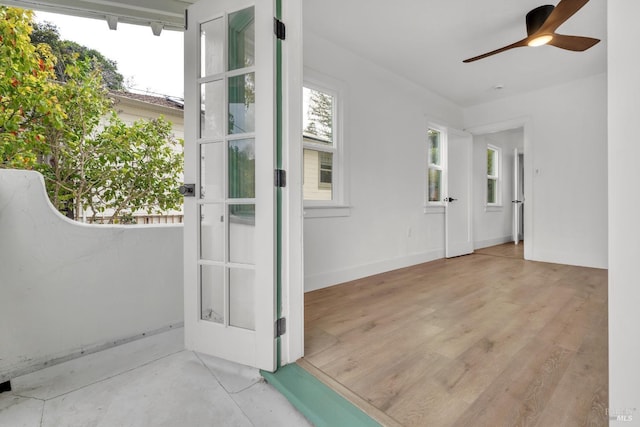 view of exterior entry with ceiling fan