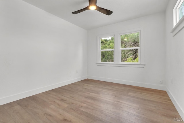 unfurnished room featuring a ceiling fan, baseboards, and light wood-style floors