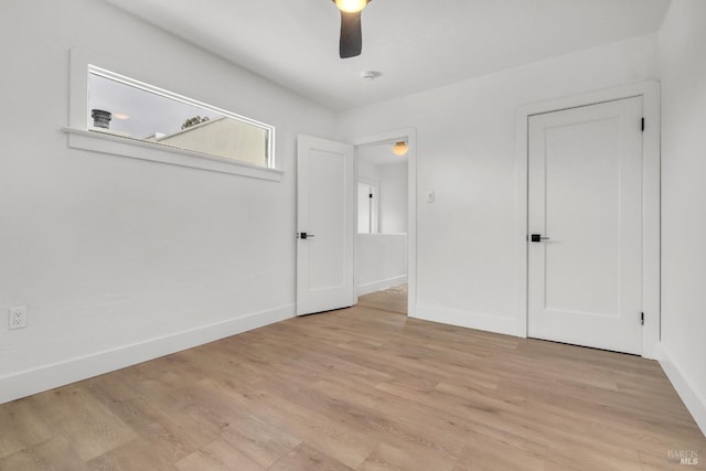 unfurnished bedroom featuring a ceiling fan, baseboards, and light wood finished floors