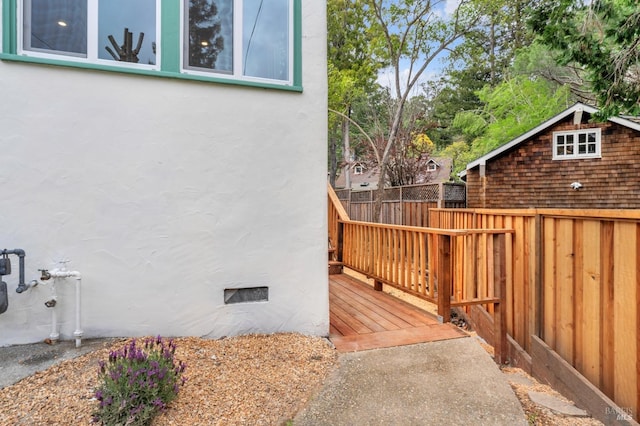 exterior space with stucco siding and a deck