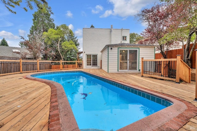 view of swimming pool with a fenced in pool, a fenced backyard, and a deck