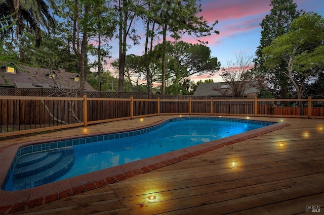 view of pool featuring a fenced backyard, a deck, and a fenced in pool