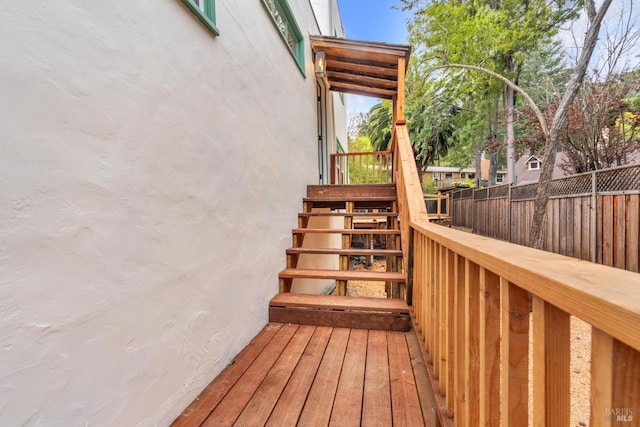 deck featuring stairs and fence