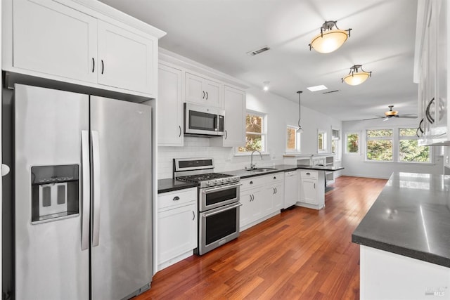 162 Wolfe Grade, Kentfield, CA 94904 - kitchen with appliances with stainless steel finishes, dark countertops, dark wood-type flooring, and white cabinetry