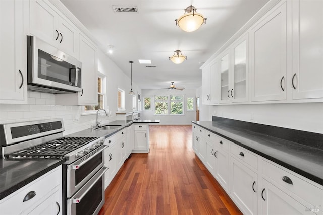 162 Wolfe Grade, Kentfield, CA 94904 - kitchen with stainless steel appliances, a sink, dark countertops, and white cabinets