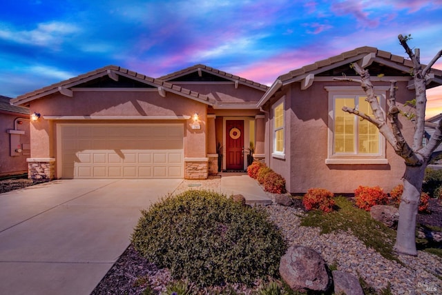 craftsman inspired home with a garage, stucco siding, stone siding, and concrete driveway