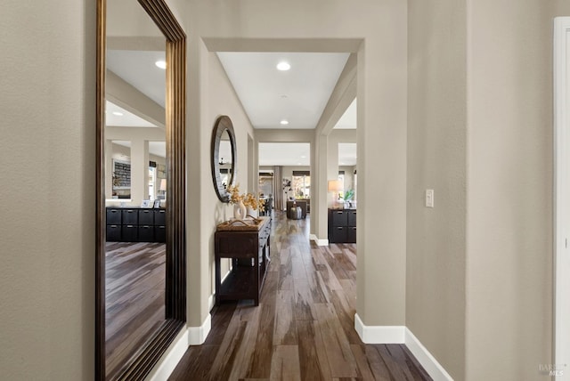 hall with baseboards, recessed lighting, and dark wood-style flooring