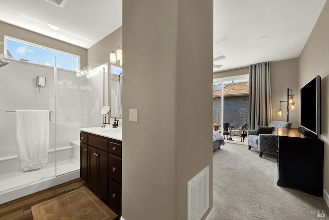 ensuite bathroom with a shower stall, vanity, ensuite bathroom, and visible vents