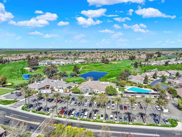 aerial view featuring golf course view, a residential view, and a water view