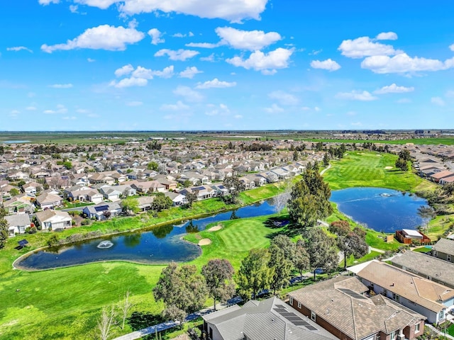 birds eye view of property with a residential view, a water view, and view of golf course