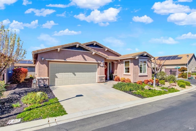 single story home with a garage, stone siding, concrete driveway, and stucco siding