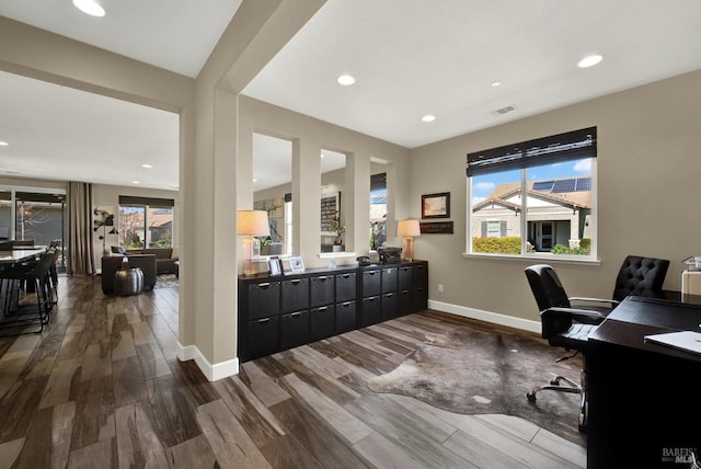 office space featuring recessed lighting, dark wood finished floors, visible vents, and baseboards